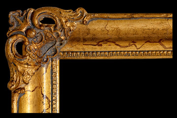 Detailed View of a Golden Ornate Picture Frame Showcasing Intricate Designs and Textures in Dim Lighting © Vantsura