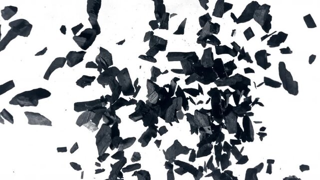 Super Slow Motion Flying and Colliding Charcoal Isolated On White Background at 1000 fps.