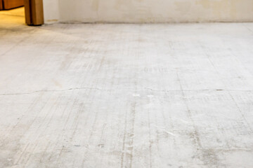 concrete screed in room with stripped flooring