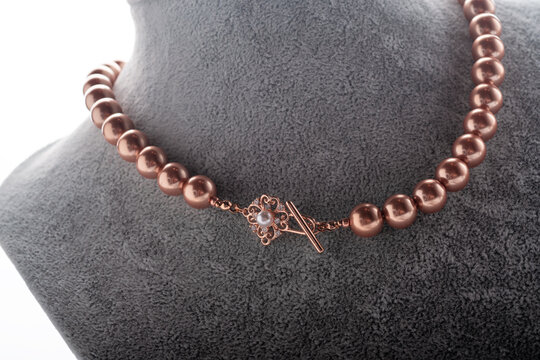 author handmade golden  pearls necklace presented on maneken. fashion and jewelry concept. macro shot