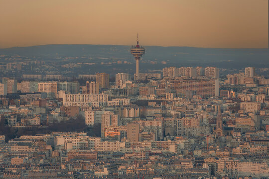 Paris, France - 03 03 2026: Montparnasse Tower: View of TDF microwave tower Romainville site, residential buildings and colorful sky behind at sunrise