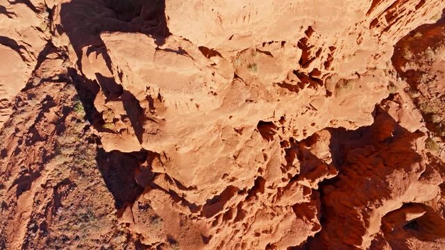 Vast rocky desert terrain showcases rugged eroded sandstone geological formations in Kyrgyzstan. Directly above drone view.
