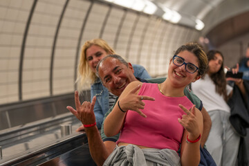 Happy caucasian families riding escalator together in New York C