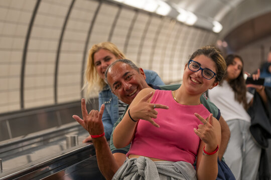 Happy caucasian families riding escalator together in New York C