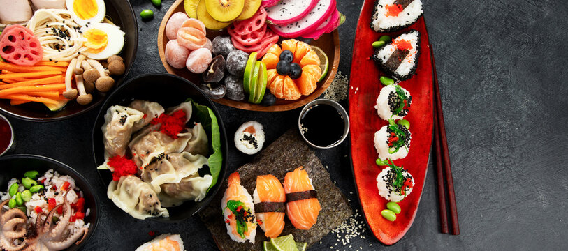 Table served with sushi and traditional japanese food.