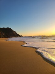 Fototapeta premium Sea foam at sunset
