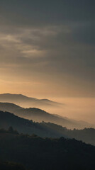Fototapeta premium Mountain range with fog at sunset