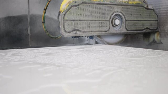Industrial CNC wet saw cutting large stone marble slab