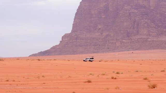 4wd towing sandboard rider across Wadi rum desert red sand speed towing extreme sport adventure Jordan