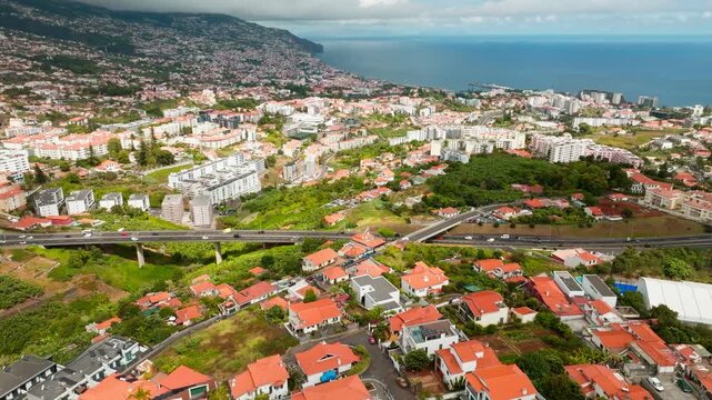 Aerial drone view of Funchal town, Madeira island, Portugal. Slide trucking shot