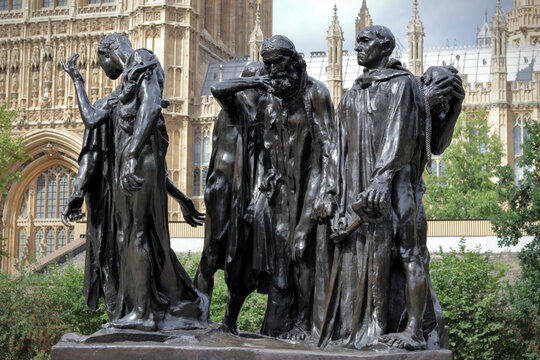 The Burghers of Calais sculpture by Auguste Rodin in London with the Palace of Westminster in the background