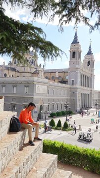 Young man reading book overlooking Madrid Spain