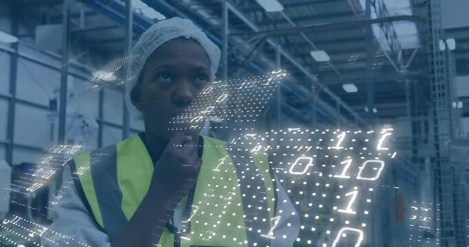Worker tapping tablet causing binary grid to grow adjusting vest checking overhead for plant checks