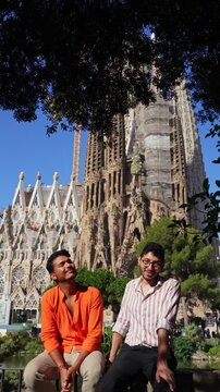 Couple sharing a kiss in front of Sagrada Fam&iacute;lia in Barcelona, Spain