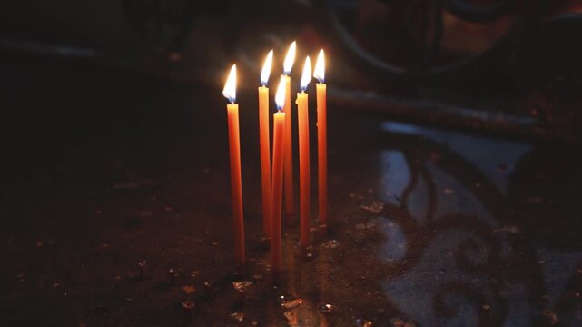 A group of lit candles sitting on a table, perfect for interior design or decorative purposes