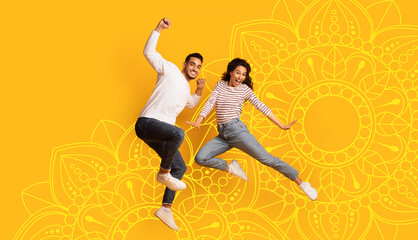 Two people are captured in motion while jumping in the air. They express happiness and energy. The...