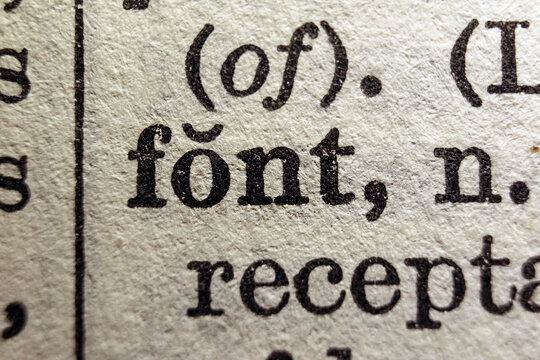 Word font printed on a dictionary page, macro closeup