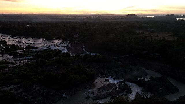 Khone Phapheng Waterfall, the largest waterfall on the Mekong River, features powerful multi-tiered cascades rushing over massive rock formations, creating one of the most dramatic natural