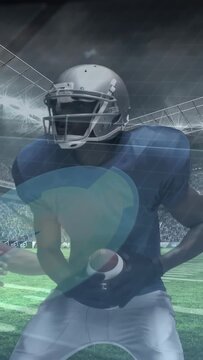 Vertical video: Blue player cradling football protecting as tackler hitting, teal overlay crossing