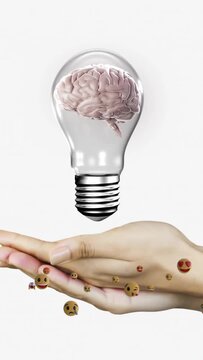 Vertical video: Hands sliding cupping as falling brain bulb centering drifting emojis for tech idea