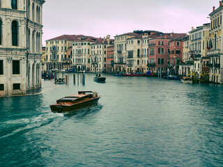Fototapeta premium Venice canal with boat and historic buildings in Italy