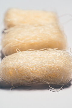 Close-up of uncooked rice noodles in neat bundles