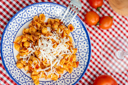 Pasta dish with tomato sauce and cheese garnish
