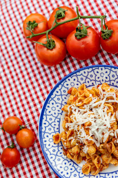 Freshly cooked pasta with tomatoes and cheese garnish