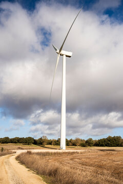 Windmill in a field generating renewable energy