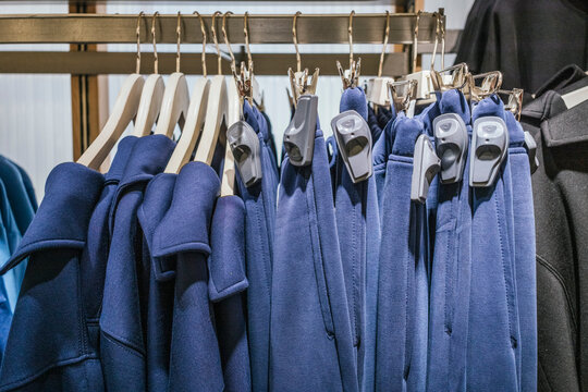 Clothes on hangers with security tags in a retail store