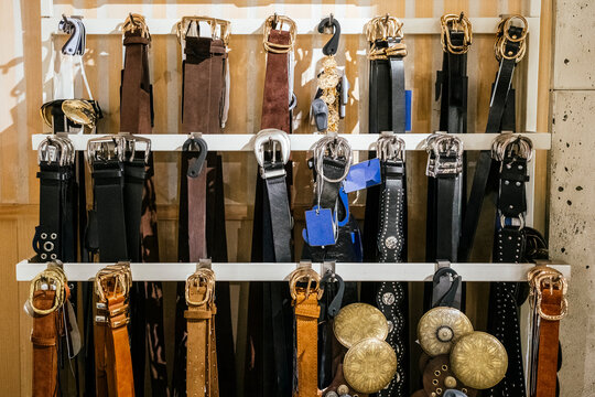 Diverse collection of stylish belts on display in store