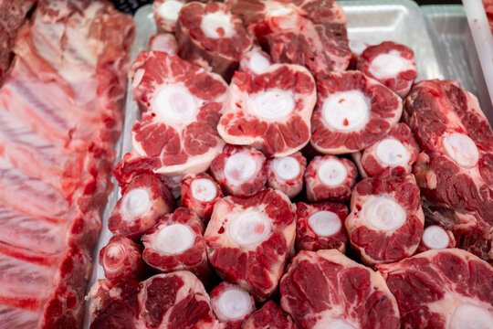 Display of fresh raw meat cuts in a butcher shop