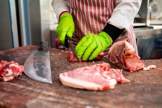 Butcher preparing meat on a cutting board