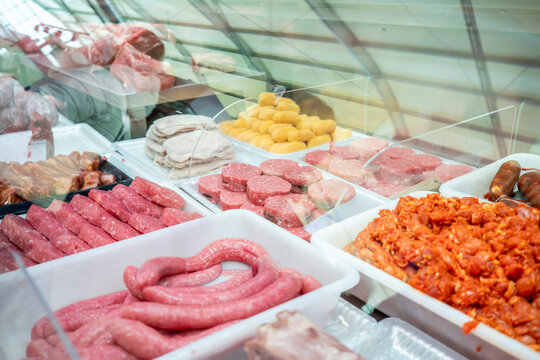 Display of various types of fresh meats in a butcher shop