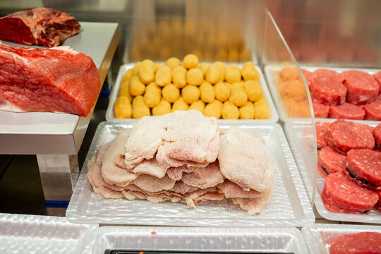 Raw and processed meat selection in a butcher shop
