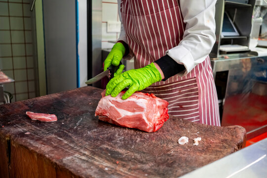 Butcher preparing fresh meat with precision and care