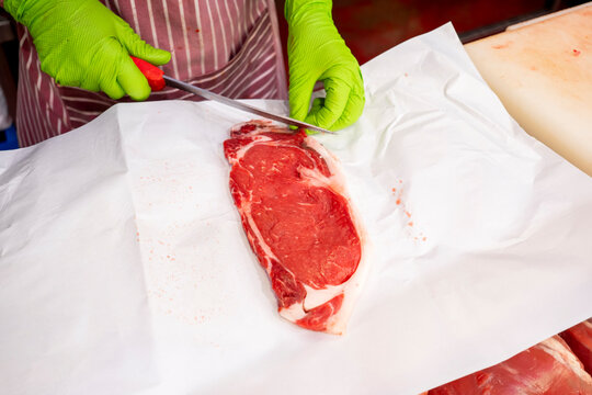 Butcher slicing fresh meat with precision