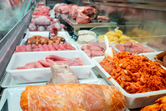 Variety of fresh meats displayed in a butcher's shop