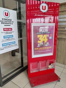 Saujon, France - October 25, 2025: Super U. Promotional display stand for U brand products featuring discounts on frozen items in a retail environment with modern design elements