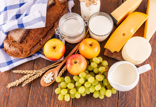 Shavuot holiday foods with bread, cheese, and fruits