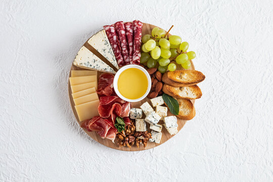 Gourmet cheese platter with fruits and nuts