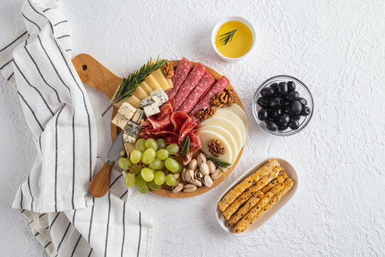 Elegant cheese platter with meats and fruits