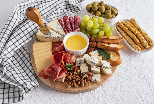 Cheese platter with assorted foods and condiments
