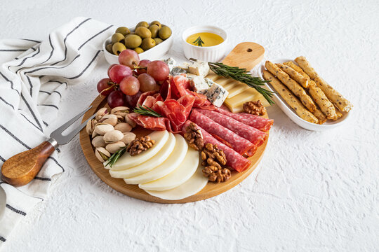 Gourmet cheese platter with cured meats and nuts