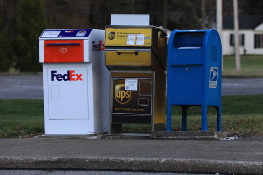 Row of mailboxes from USPS, Fedex, and UPS.