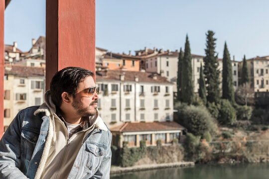 Man relaxing on a bridge in Bassano del Grappa, Italy