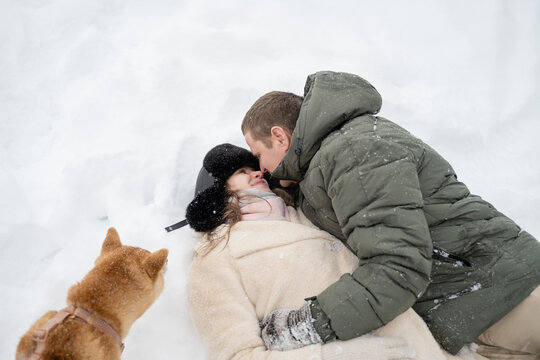 Couple enjoying a winter walk with their dog