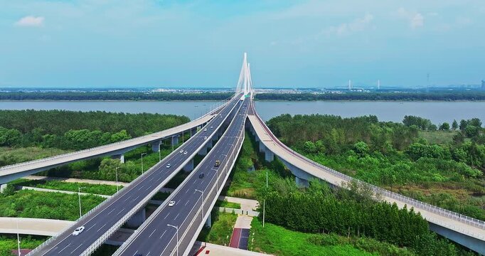 Modern cable-stayed bridge and complex highway interchange crossing the Yangtze River in Nanjing, China.