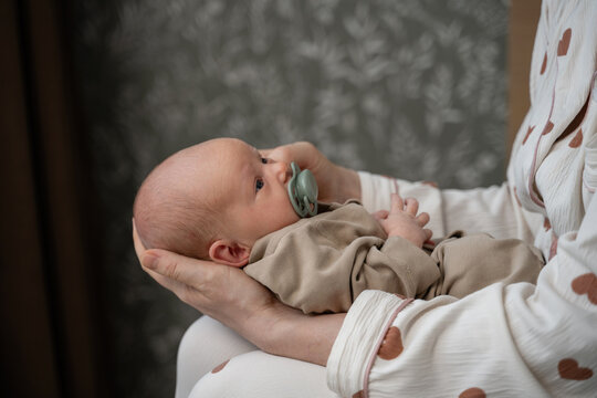 Gentle embrace of newborn in cozy home setting