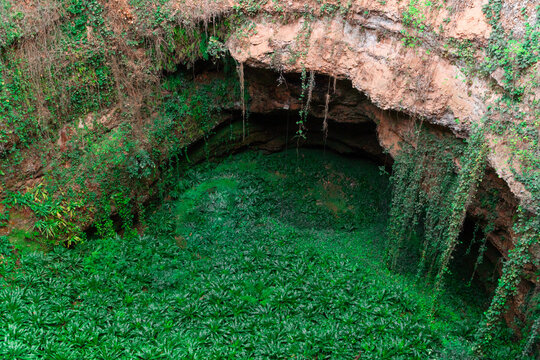 The sinkhole of Los Aines with lush greenery